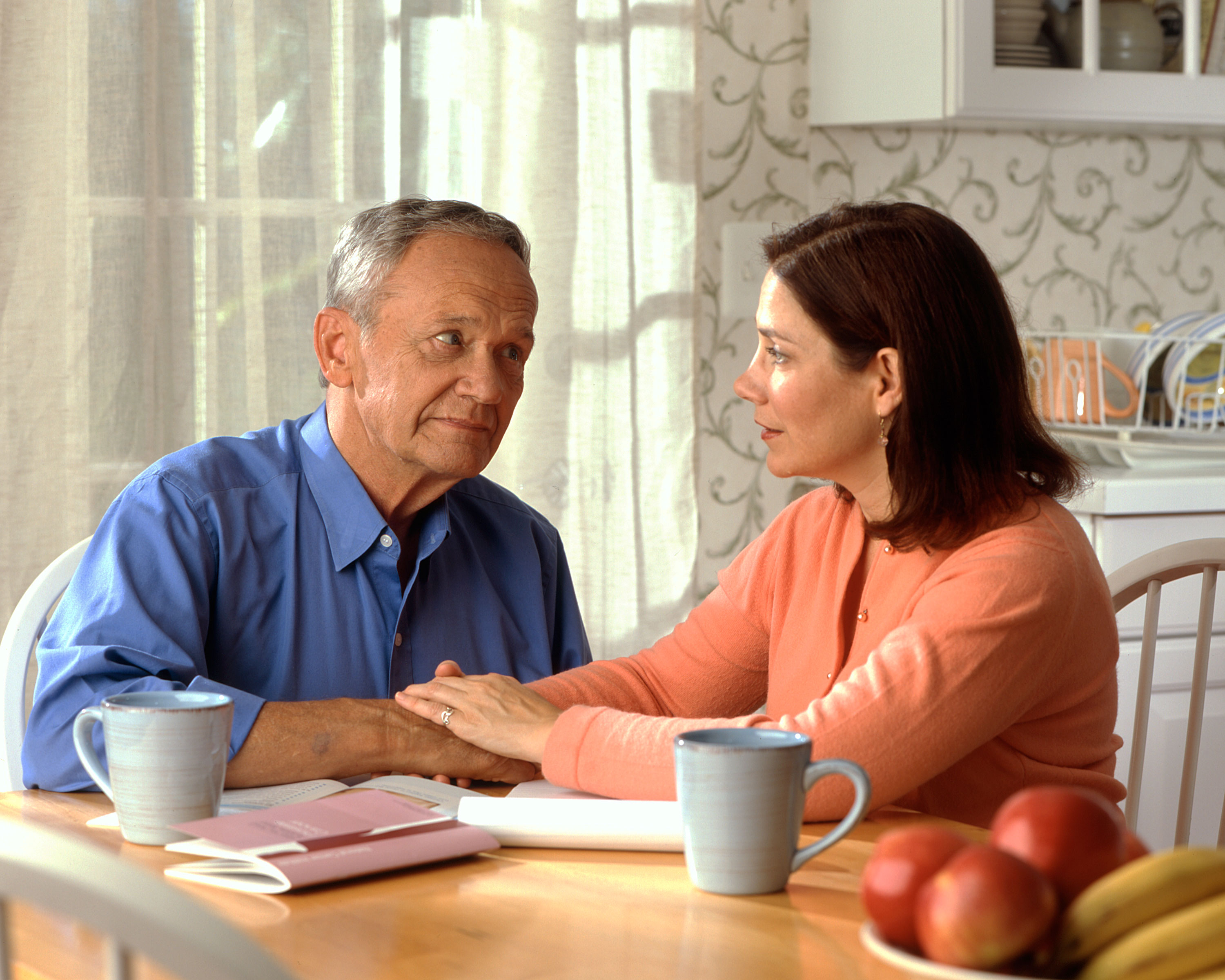 couple_sitting_at_a_kitchen_table_1
